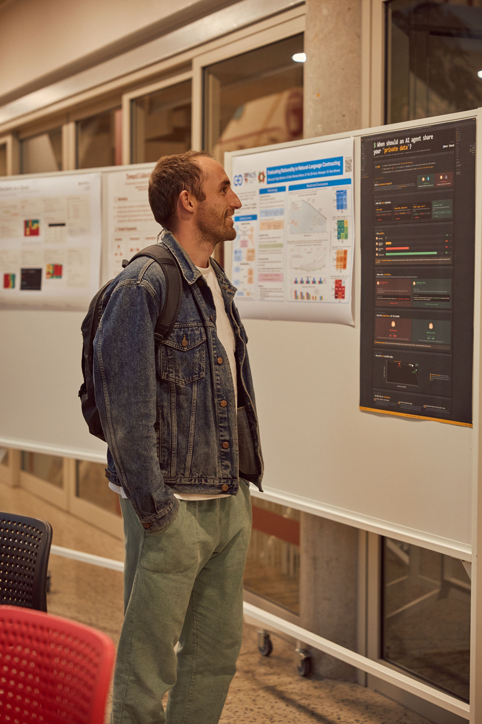 Claude standing beside Cooperative AI Research Fellowship posters